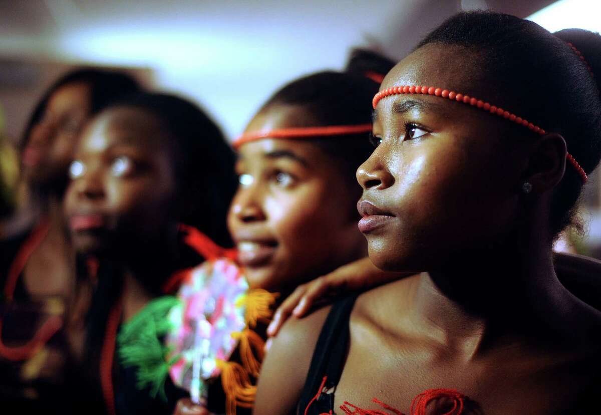 Stephanie Merem, right, and other members of the dance group "The Sisters" attend the annual Christmas party for Nigerian children of San Antonio at St. Matthew Catholic Church on Saturday night, Dec. 22, 2012. The event was sponsored by professional Nigerian culture women.