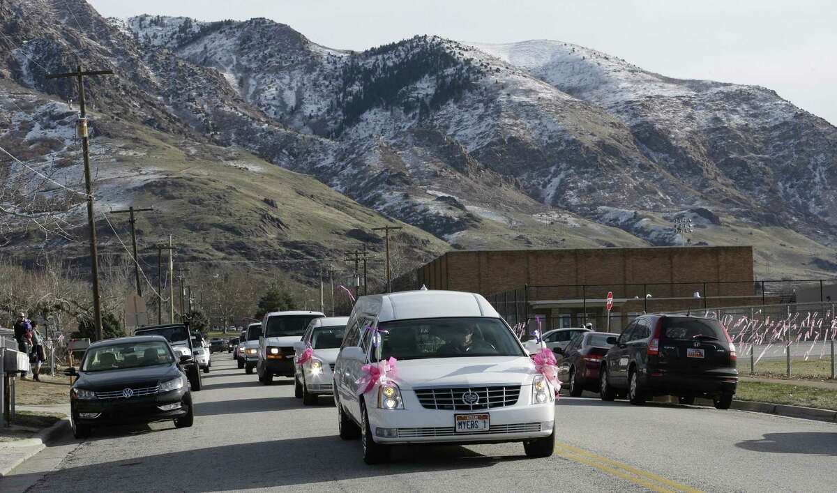 A hearse carrying the casket Emilie Parker drives along the street following funeral services on Saturday, Dec. 22, 2012, in Ogden, Utah. Emilie, 6, whose family has Ogden roots, was one of 20 children and six adult victims killed in a Dec. 14 mass shooting at Sandy Hook Elementary in Newtown, Conn.