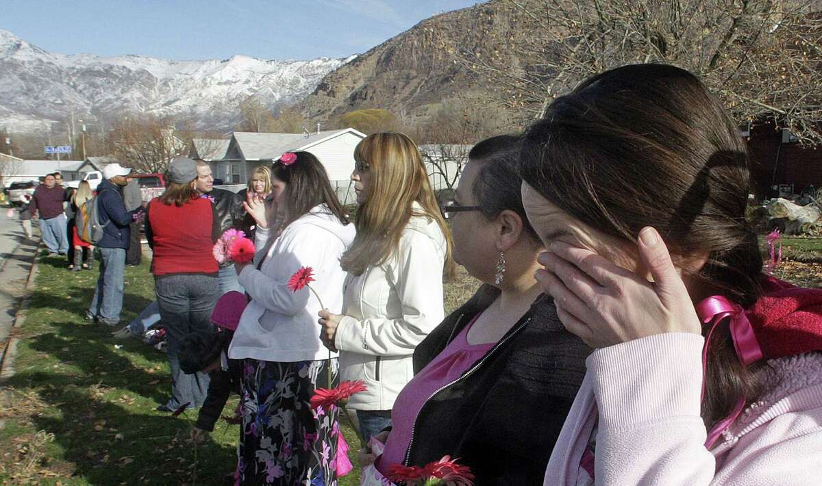 Mournier Claudia Wardle cries after the hearse carrying Emilie Parker passed by following funeral services for the 6-year old Connecticut elementary shooting victim, Saturday, Dec. 22, 2012, in Ogden, Utah. Emilie, whose family has Ogden roots, was one of 20 children and six adult victims killed in a Dec. 14 mass shooting at Sandy Hook Elementary in Newtown, Conn.