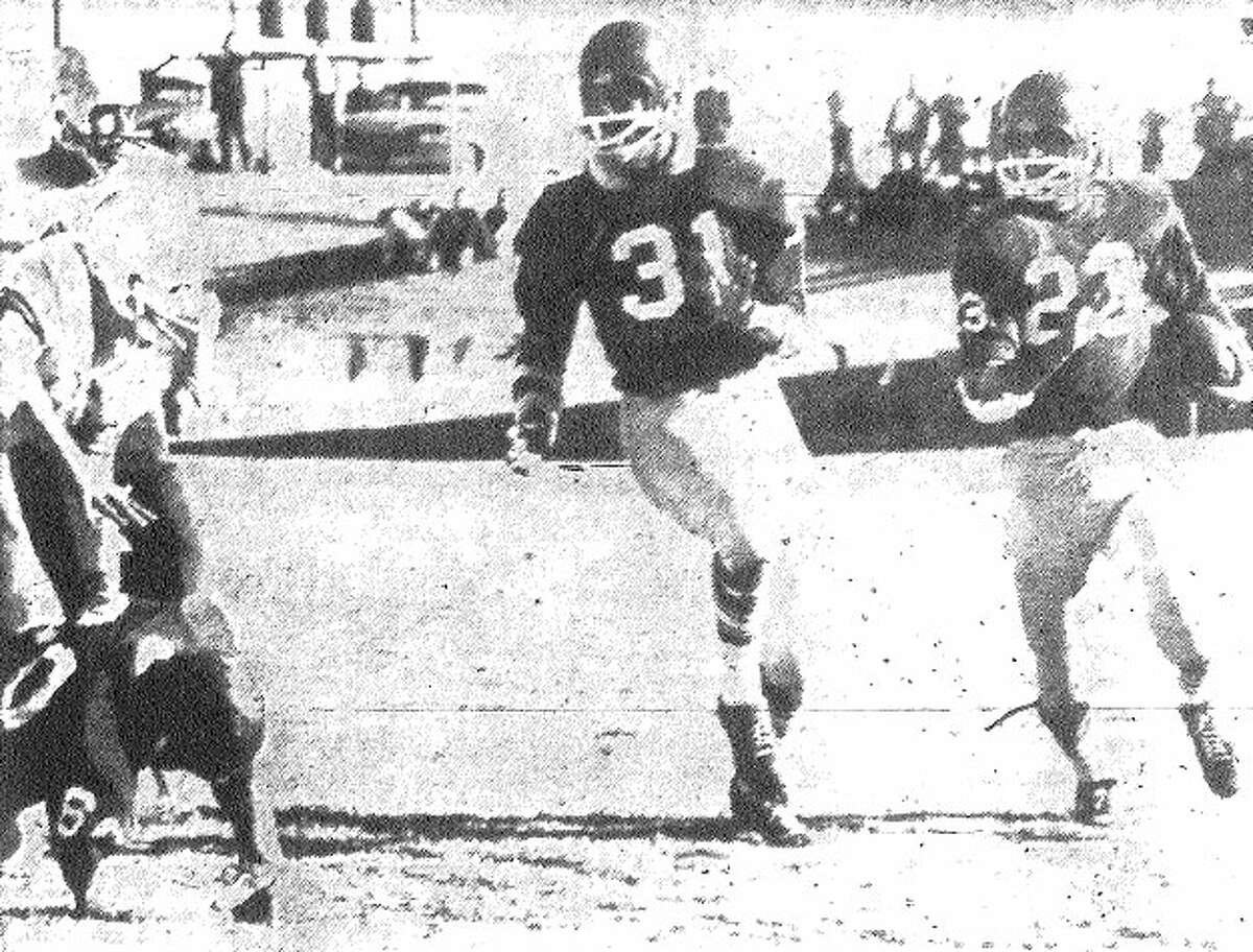 Brackenridge's Pete Bautista (right) has teammate Floyd Boone (31) blocking in front of him as Bautista returns a kickoff against Borger. File photo