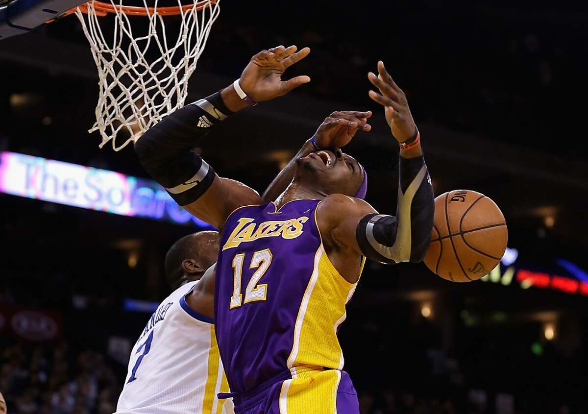 OAKLAND, CA - DECEMBER 22: Dwight Howard #12 of the Los Angeles Lakers is fouled by Carl Landry #7 of the Golden State Warriors at Oracle Arena on December 22, 2012 in Oakland, California. NOTE TO USER: User expressly acknowledges and agrees that, by downloading and or using this photograph, User is consenting to the terms and conditions of the Getty Images License Agreement. (Photo by Ezra Shaw/Getty Images)