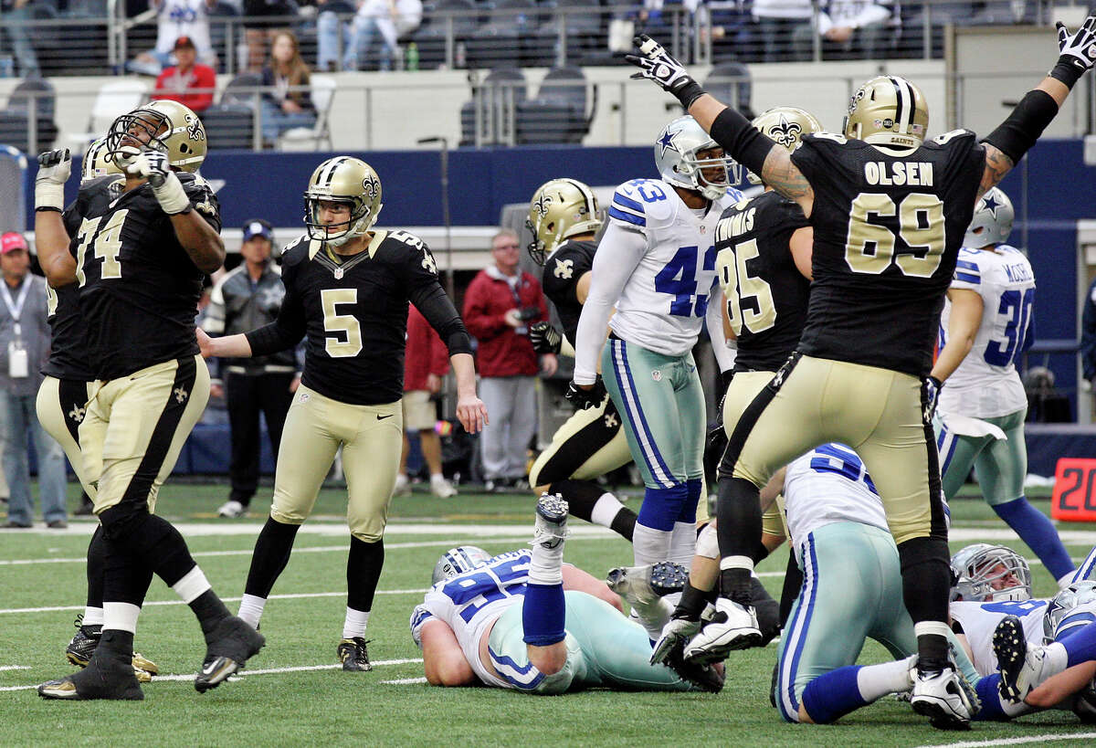New Orleans Saints' Garrett Hartley (left center) and teammates react after Hartley made a field goal to win the game during overtime action against the Dallas Cowboys Sunday Dec. 23, 2012 at Cowboys Stadium in Arlington, Tx. The Saints won 34-31.
