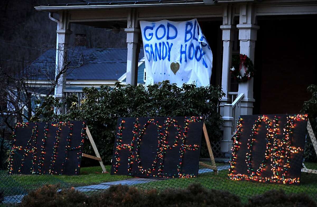 A sign in the Sandy Hook neighborhood of Newtown, Conn. Friday, Dec. 21, 2012 near a memorial for the victims of the Sandy Hook Elementary School shooting.