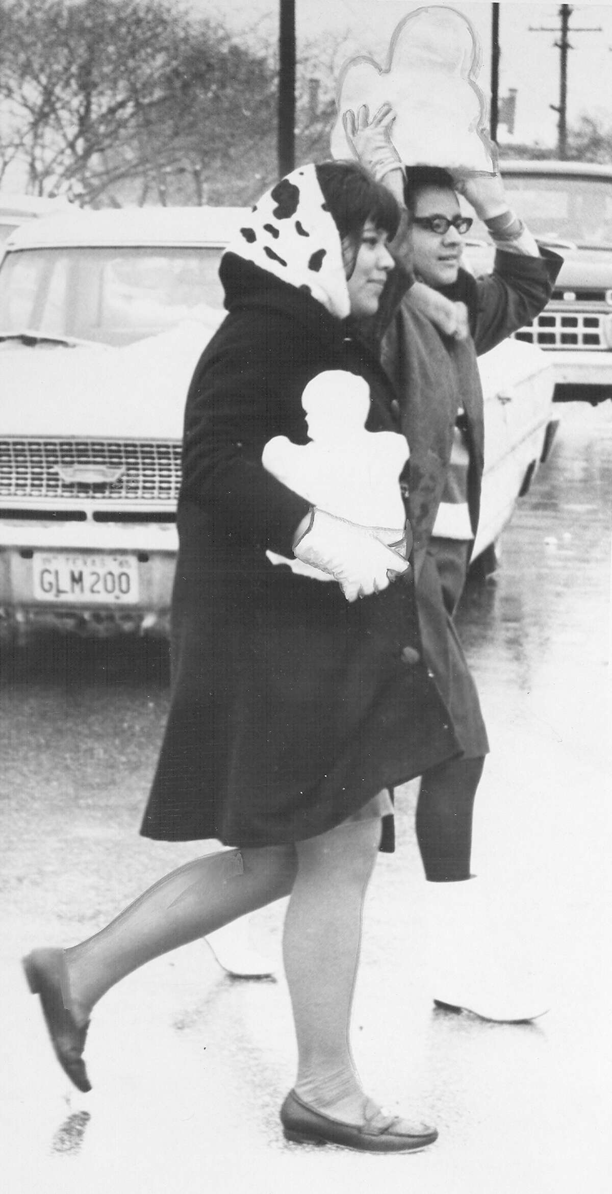Two women carry small snowmen after a snow storm in San Antonio on Feb. 22, 1966.