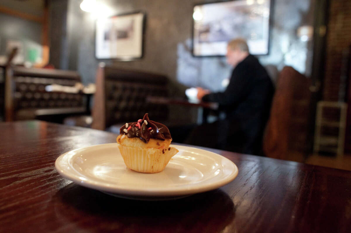 A cupcake sits on a table at the Stone River Grille after it was given to a customer on Friday, December 21, 2012. Earlier in the day the family of Grace McDonnell stopped by the restaurant and ordered cupcakes for all the customers that came into the restaurant that day. McDonnell, 7, one of the students killed at Sandy Hook Elementary, loved cupcakes.