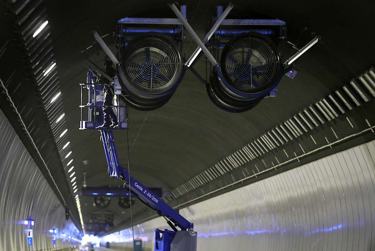A crew works on giant exhaust fans suspended inside the Devil's Slide Tunnel in Pacifica, Calif. on Friday, Dec. 21, 2012. Caltrans plans to open the twin bores early next year.