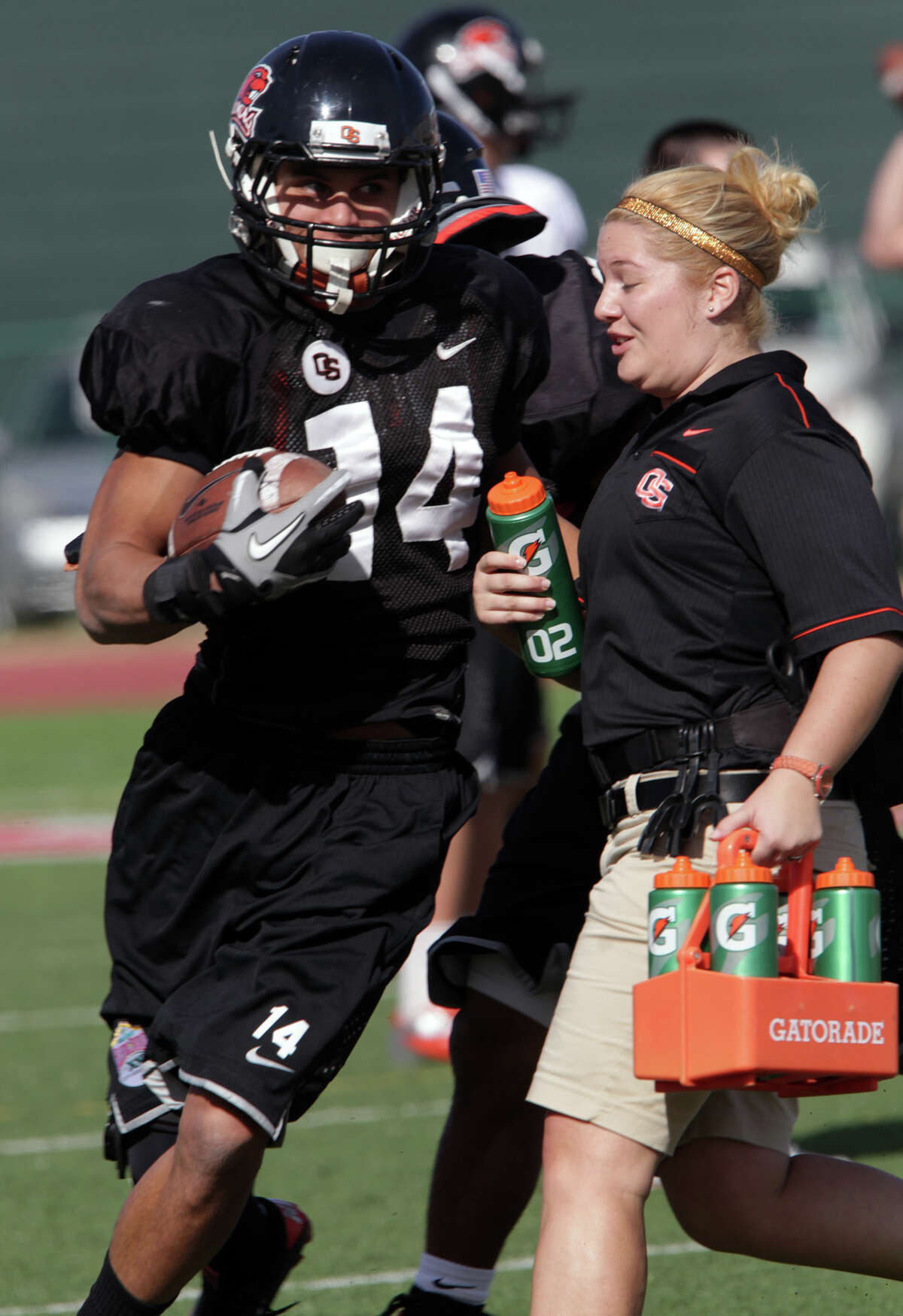 Oregon State Beavers Jordan Poyer nearly colides with a trainer during practice at Benson Stadium, University of the Incarnate Word. Monday, Dec. 24, 2012.