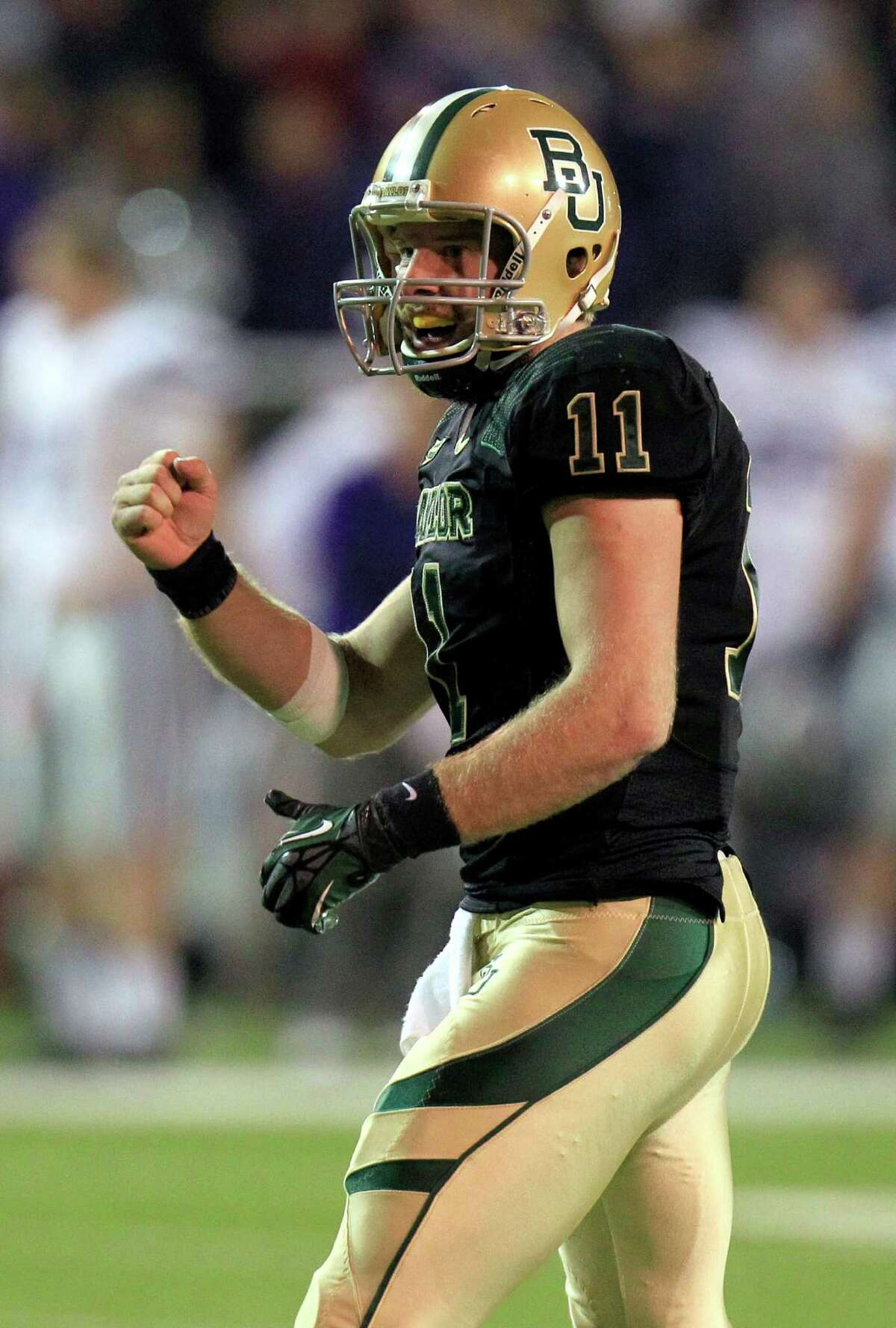Baylor quarterback Nick Florence (11) celebrates a touchdown during the third quarter for the NCAA college football game against Kansas State, Saturday, Nov. 17, 2012, in Waco Texas. (AP Photo/LM Otero)