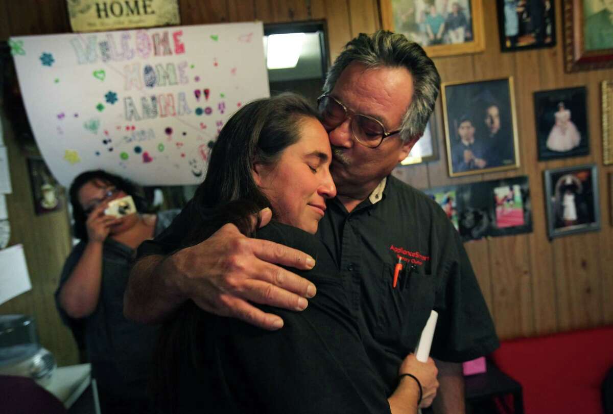 Anna Vasquez hugs one of her older brothers, Robert Vasquez, as they embrace each other for the first time in 12 and a half years. Anna, one of the four San Antonio women fighting to clear their names in the 1994 sexual assault of two sisters, was released from prison on parole from the Crain Unit in Gatesville, TX . At left is Rose Vasquez, Anna's sister-in-law, taking pictures. Friday, Nov. 2, 2012. Click to browse all of the EN's most memorable photos of 2012