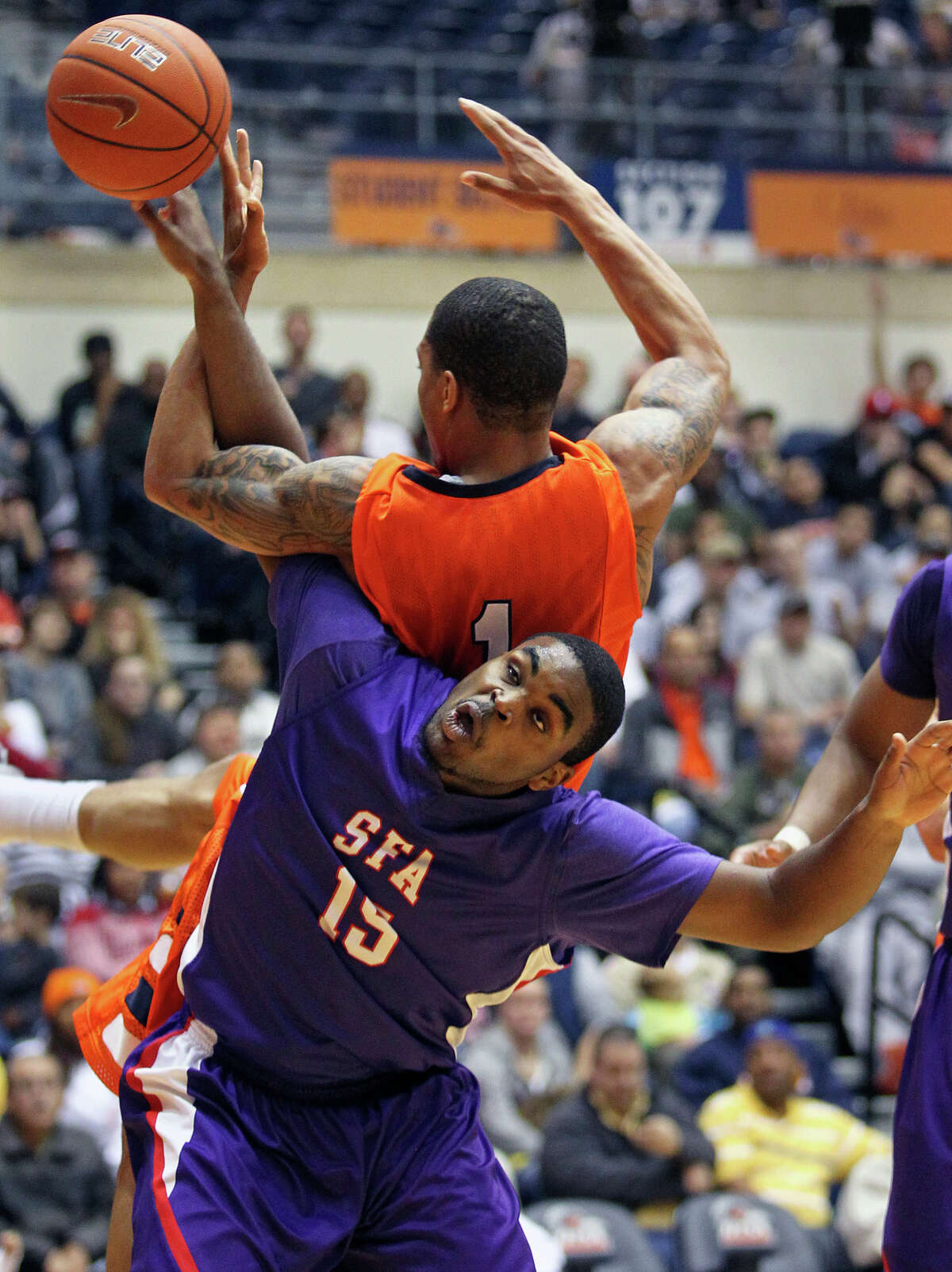 SFA's Joe Bright moves under the rebounding effort of Stephen Franklin and is called for a position foul as the Roadrunners play the SFA Lumberjacks at the UTSA Convocation Center on February 11, 2012.
