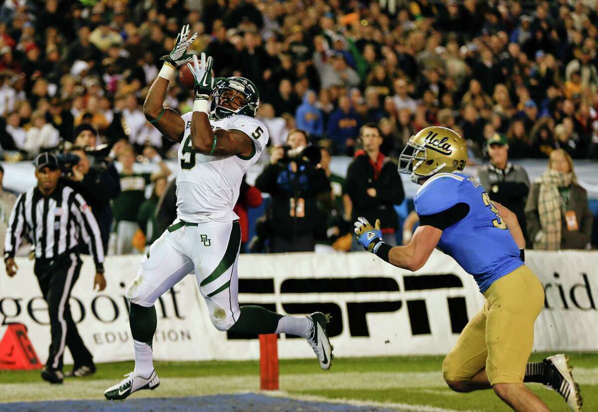 Baylor wide receiver Antwan Goodley (5) hauls in a 8-yard touchdown pass after beating UCLA linebacker Jordan Zumwalt during the first half of the NCAA college football Holiday Bowl game Thursday, Dec. 27, 2012, in San Diego. (AP Photo/Lenny Ignelzi)