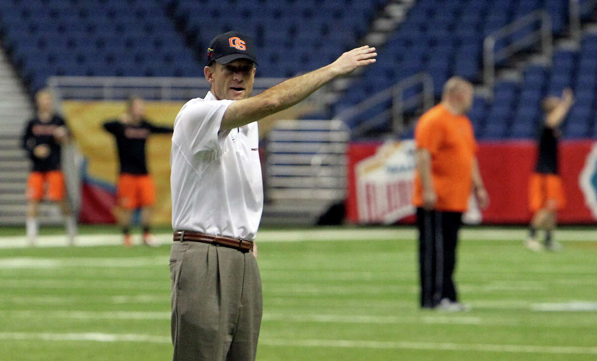 Oregon State head coach Mike Riley waves to players to commence a walk-through practice at the Alamodome for their game against the University of Texas in the Valero AlamoBowl on Friday, Dec. 28, 2012.