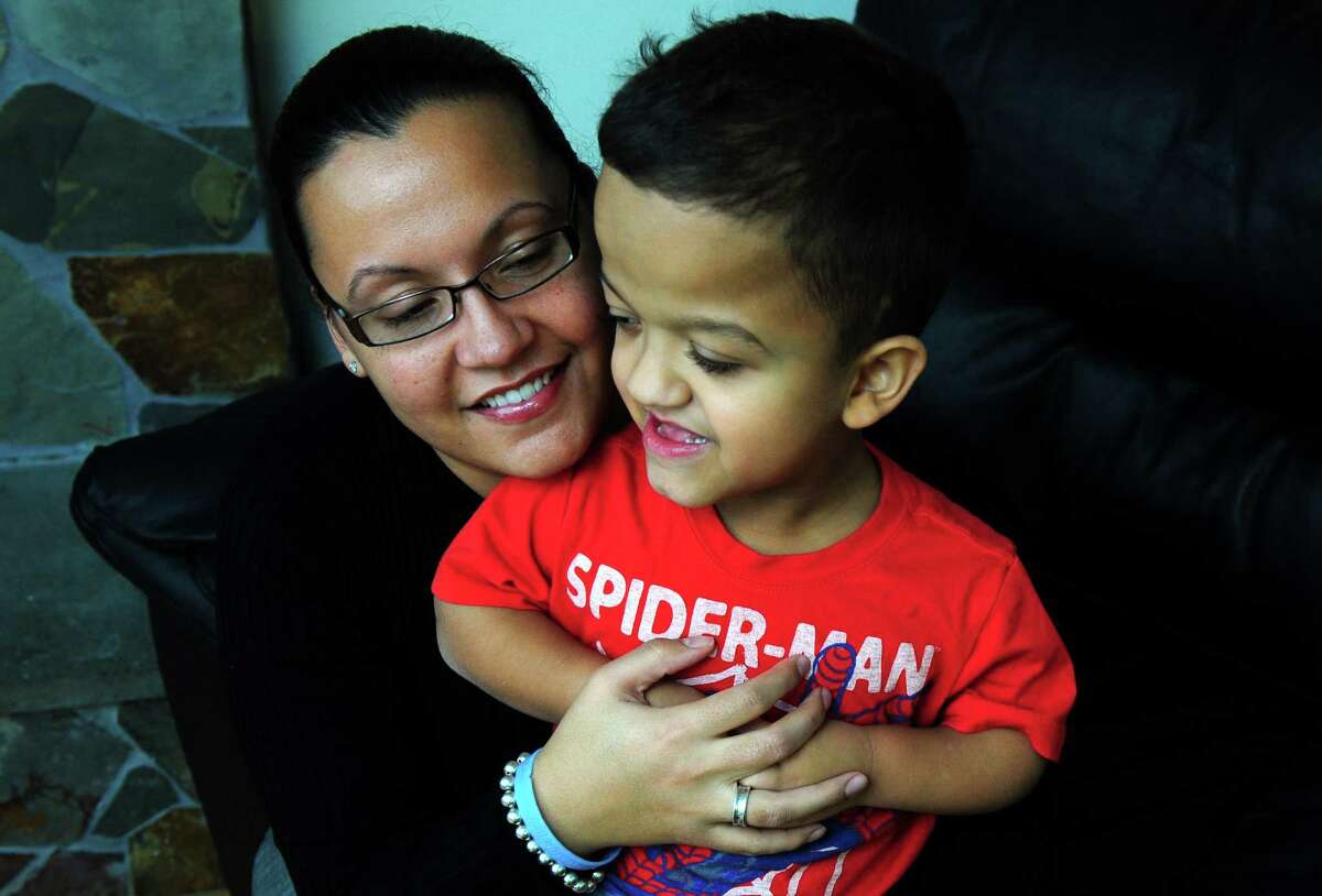 Leticia Crespo, of Monroe, holds her 7-year-old son, Jaden, who has autism, at their home in Monroe, Conn. Crespo fears that reports linking Adam Lanza to autism spectrum disorders will hinder efforts to remove the stigma about the condition.