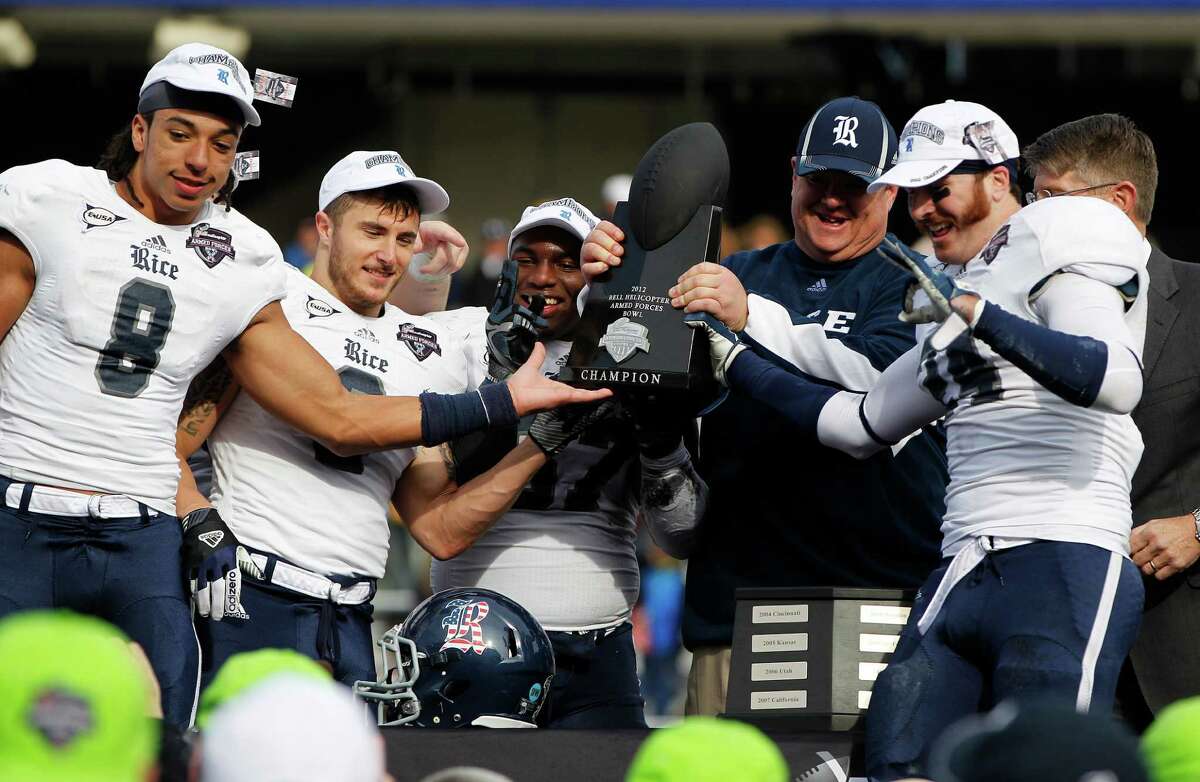 Rice head coach David Bailiff and his players celebrate with the trophy after their win during the Bell Helicopter Armed Services Bowl at Amon G. Carter Stadium, Saturday, Dec. 29, 2012, in Ft. Worth.