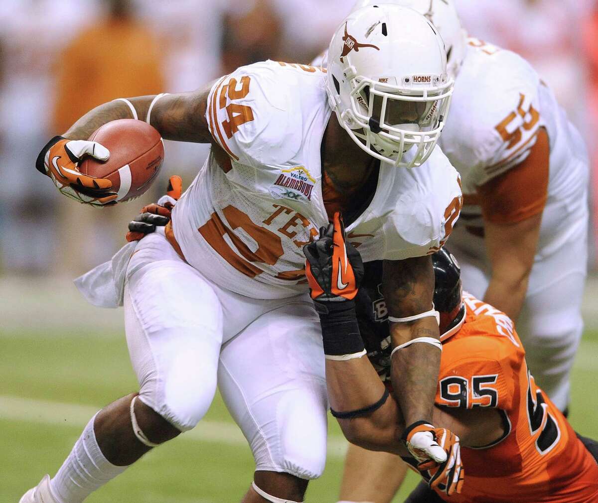 Texas running back Joe Bergeron is dragged down by his shirt collar by Oregon State defender Scott Crichton (95) during Valero Alamo Bowl action in the Alamodome on Saturday, Dec. 29, 2012.