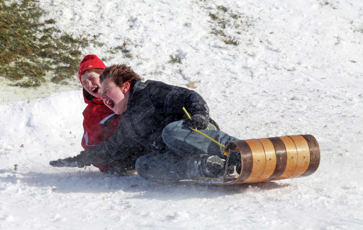 Ryan Kramer, 7, and Chris Imbro, 12, both of Milford, sled at Jonathan Law High School in Milford, Conn. on Sunday, December 30, 2012.
