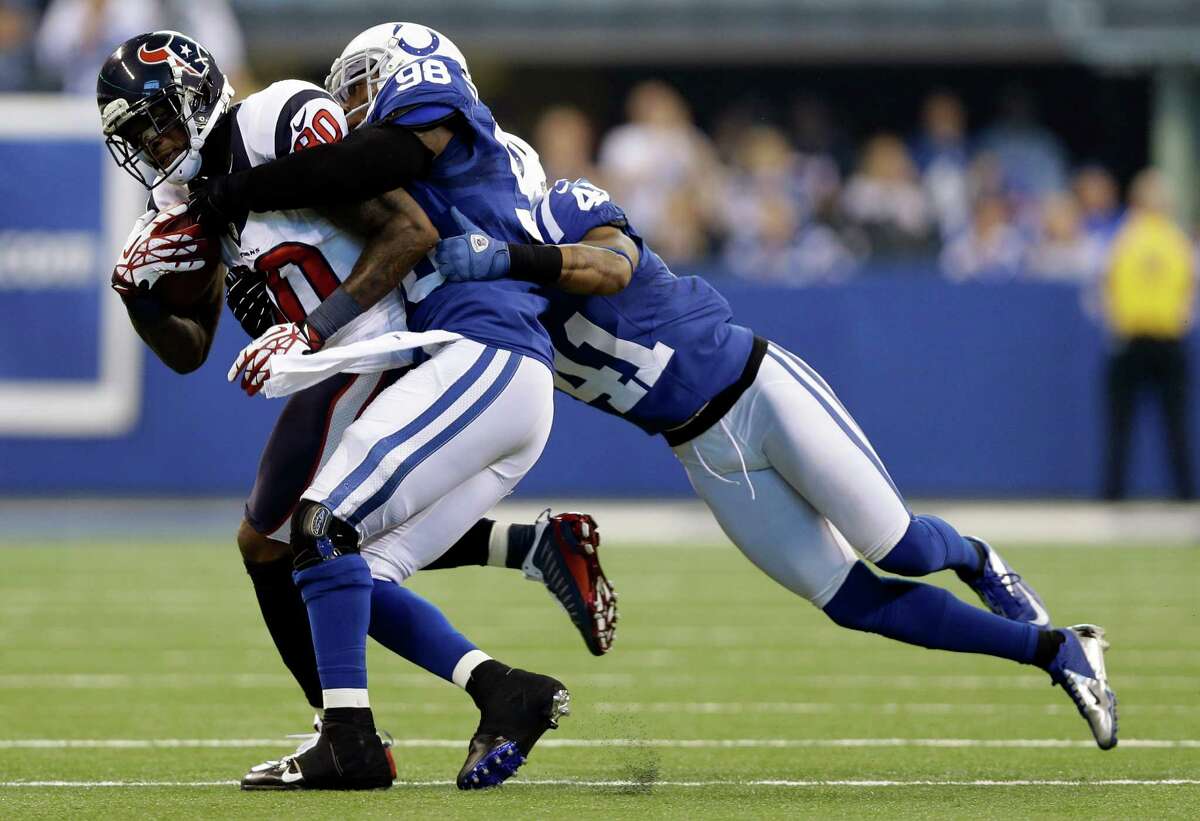 Houston Texans' Andre Johnson (80) is tackled by Indianapolis Colts' Robert Mathis (98) and Antoine Bethea (41) during the first half of an NFL football game on Sunday, Dec. 30, 2012, in Indianapolis. (AP Photo/Michael Conroy)