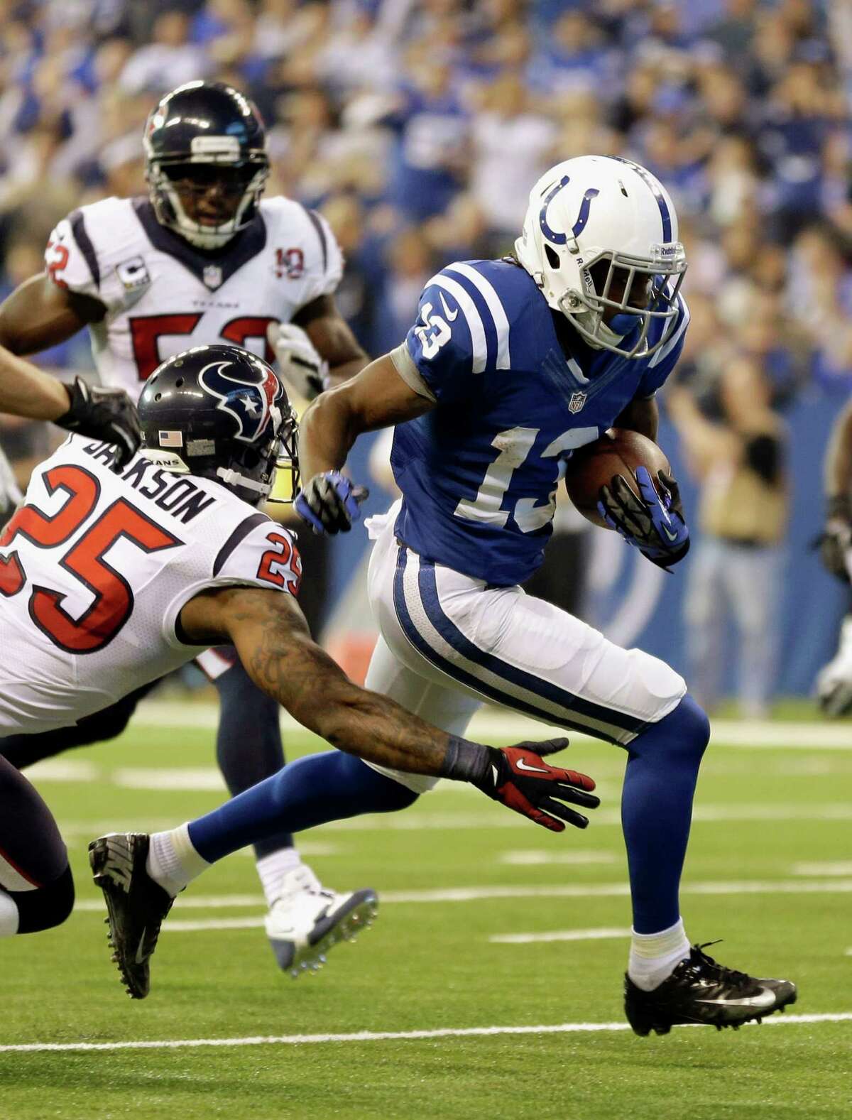 Houston Texans' Kareem Jackson (25) tackles Indianapolis Colts' T.Y. Hilton (13) during the first half of an NFL football game, Sunday, Dec. 30, 2012, in Indianapolis. (AP Photo/Michael Conroy)