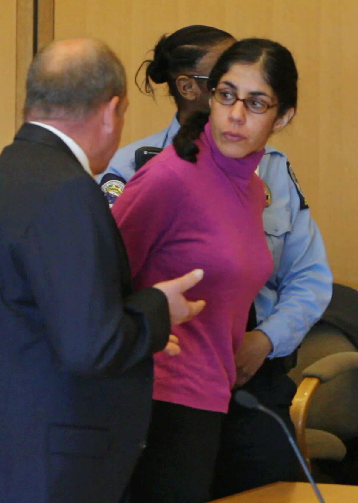 Sheila Davalloo looks back at the court room following her sentencing for the murdering Anna Lisa Raymundo, at Superior Court in Stamford Conn., Friday, April 27, 2012. At left is Barry Butler, Chief Public Defender for the Stamford Norwalk Judicial Courts and Davalloo’s court appointed legal aide. (AP Photo/The Journal News, Matthew Brown, Pool)