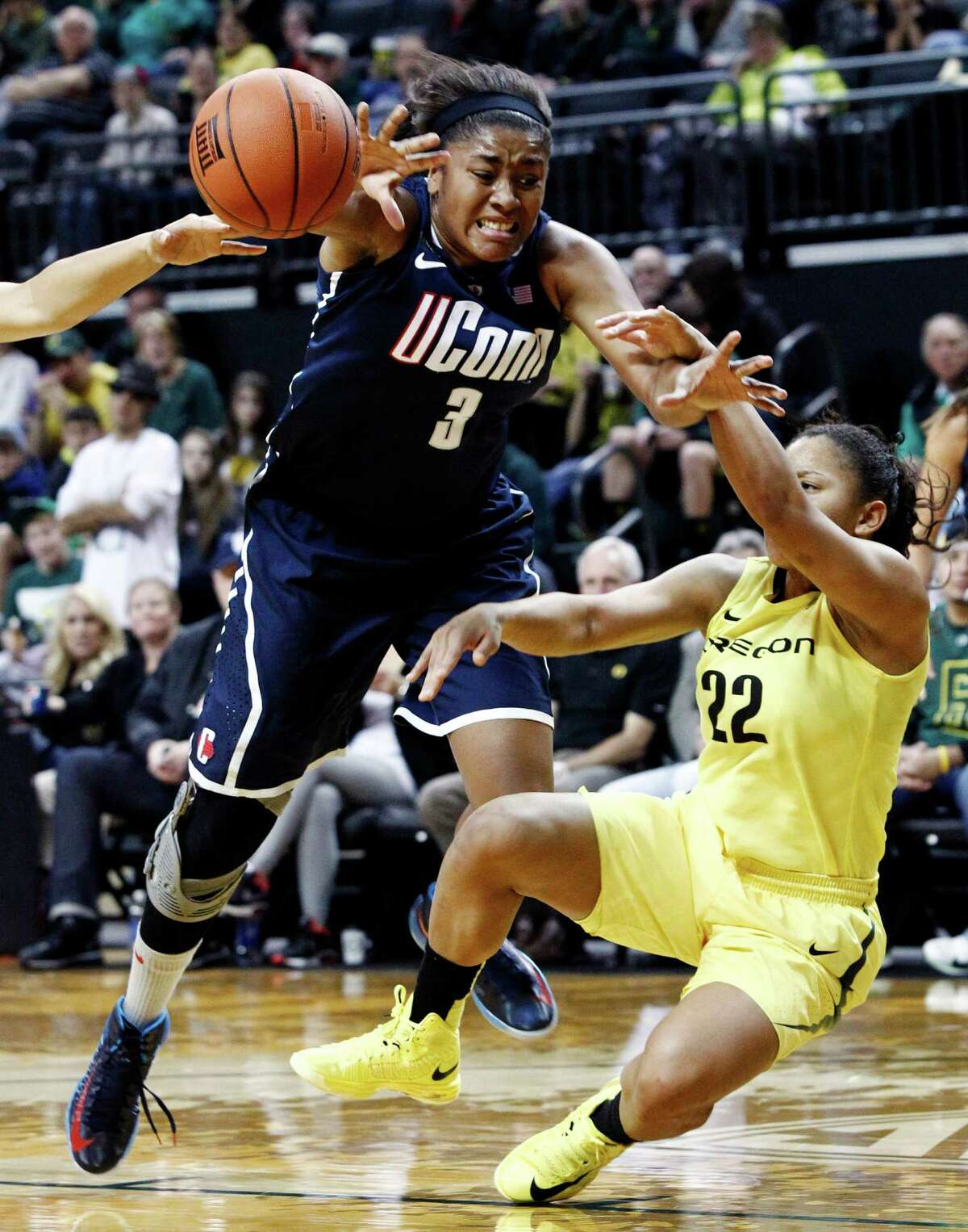 Connecticut forward Morgan Tuck, left, is fouled on her way to the basket by Oregon guard Ariel Thomas during the second half of an NCAA college basketball game in Eugene, Ore., Monday, Dec. 31, 2012. Connecticut won 95-51. (AP Photo/Don Ryan)