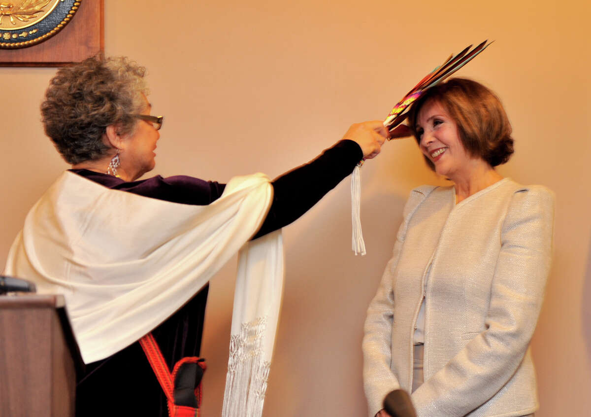 Newly elcted 438th Judicial District Court Judge Gloria Saldana (right) is blessed by Gloria Camarillo Vasquez, Elder of The Tap Pilam Coahuiltecan Nation during sweaing-in ceremonies Tuesday.
