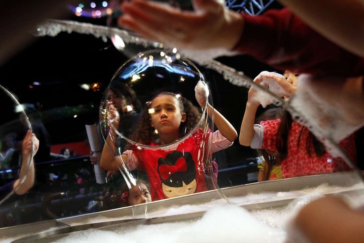 Raven Placido, 7, of Castro Valley, makes giant bubbles on the last day the Exploratorium is open in San Francisco, Calif., Wednesday, January 2, 2013. After Wednesday the Exploratorium will be closed while it moves to its new location at Pier 15.