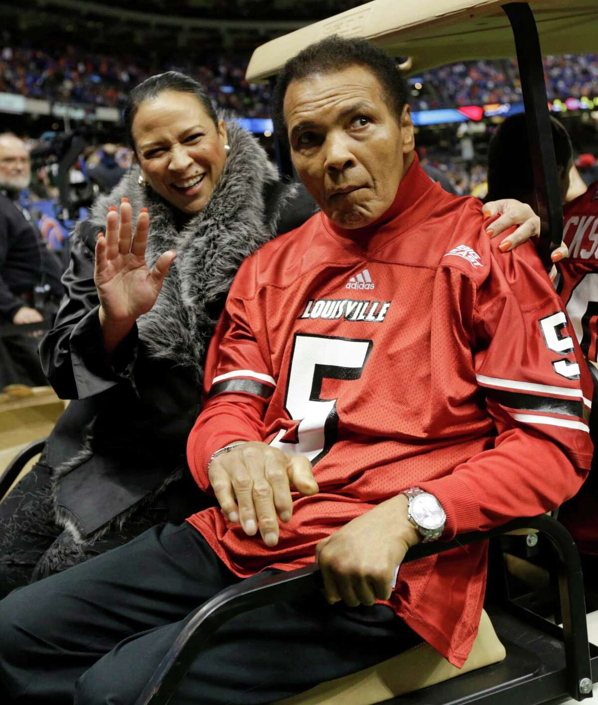 Former boxing legend Muhammad Ali arrives for the coin toss prior to the start of the Sugar Bowl NCAA college football game between Florida and Louisville on Wednesday, Jan. 2, 2013, in New Orleans. (AP Photo/Dave Martin)