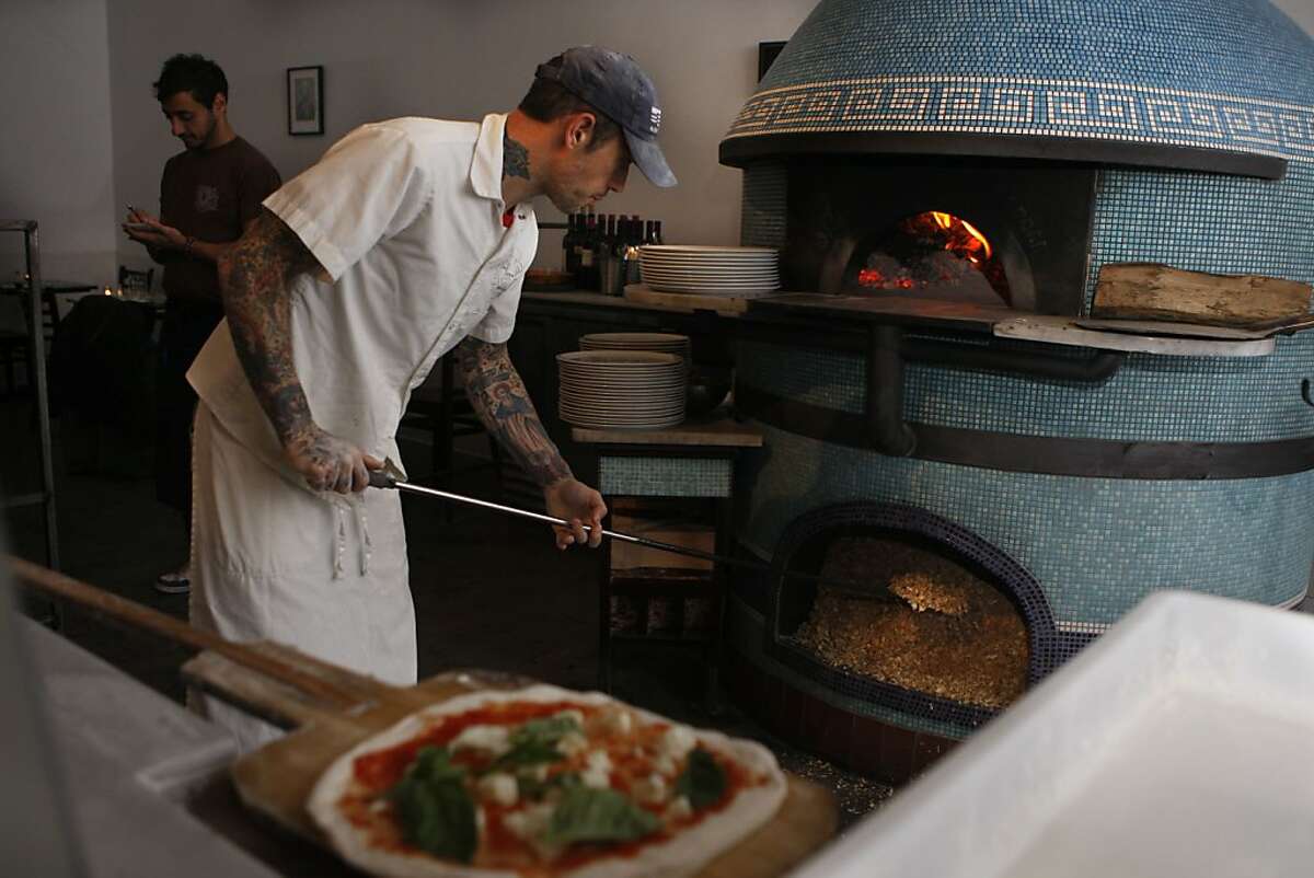 Chef Anthony Mangieri of Una Pizza Napoletana making pizzas during dinner time in San Francisco, California, on Thursday, December 20, 2012. Closing his original pizzeria in the East Village in New York, he's opened one here and makes just enough dough for 100 pies a day, offering just four types of pizza, and makes it in his wood burning stove.