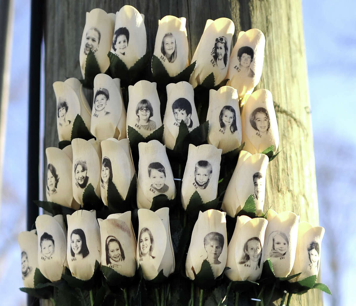 Roses with the faces of the Sandy Hook Elementary students and adults killed are seen on a pole in Newtown, Connecticut on January 3, 2013.