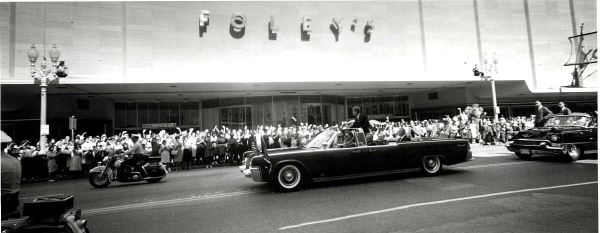 President John F. Kennedy greets Houstonians as his motorcade drives past Foley's in 1962.