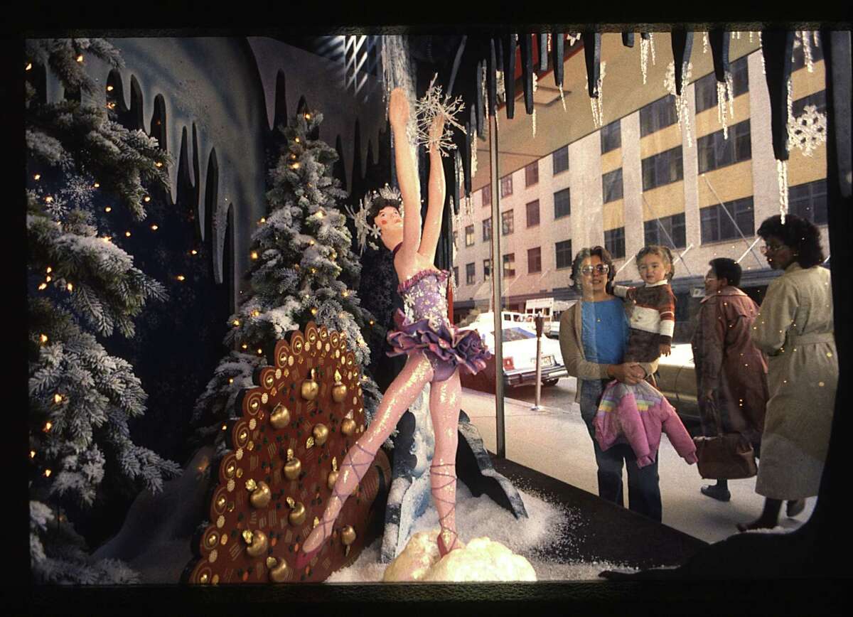 11/19/1984 - Foley's brings back animated windows for the Christmas season. Pedestrians pass by the "Land of Snow" scene from the Nutcracker Ballet. Each of the four windows on Main Street displays a different stage set with animated characters from the Nutcracker Ballet. Micheal Boddy / Houston Post