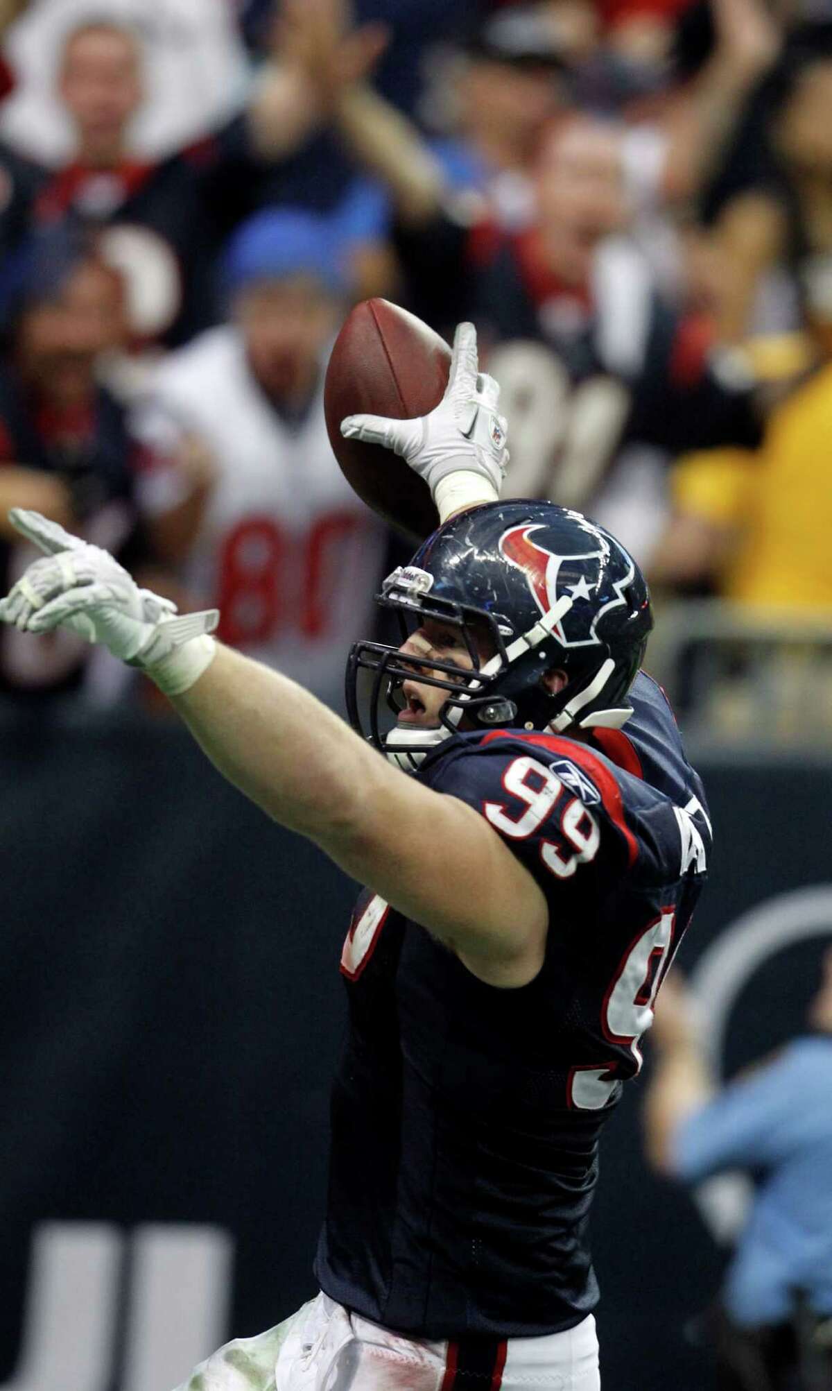 Texans defensive end J.J. Watt celebrates after returning an interception 29 yards for a touchdown against the Bengals in last season's wild-card victory at Reliant Stadium.