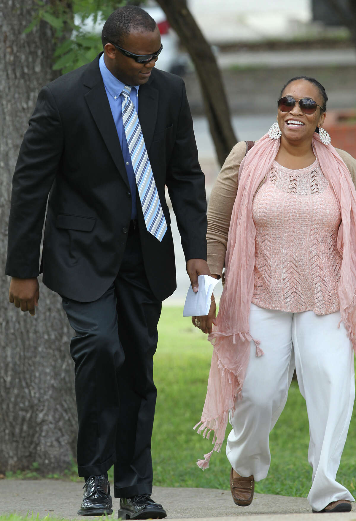 Suspended San Antonio police officer Curtis Lundy (left) walks to the Federal Courthouse Thursday October 10, 2013. Lundy,36, has been charged with bribery for taking money in exchange for not filing criminal charges against a suspect.