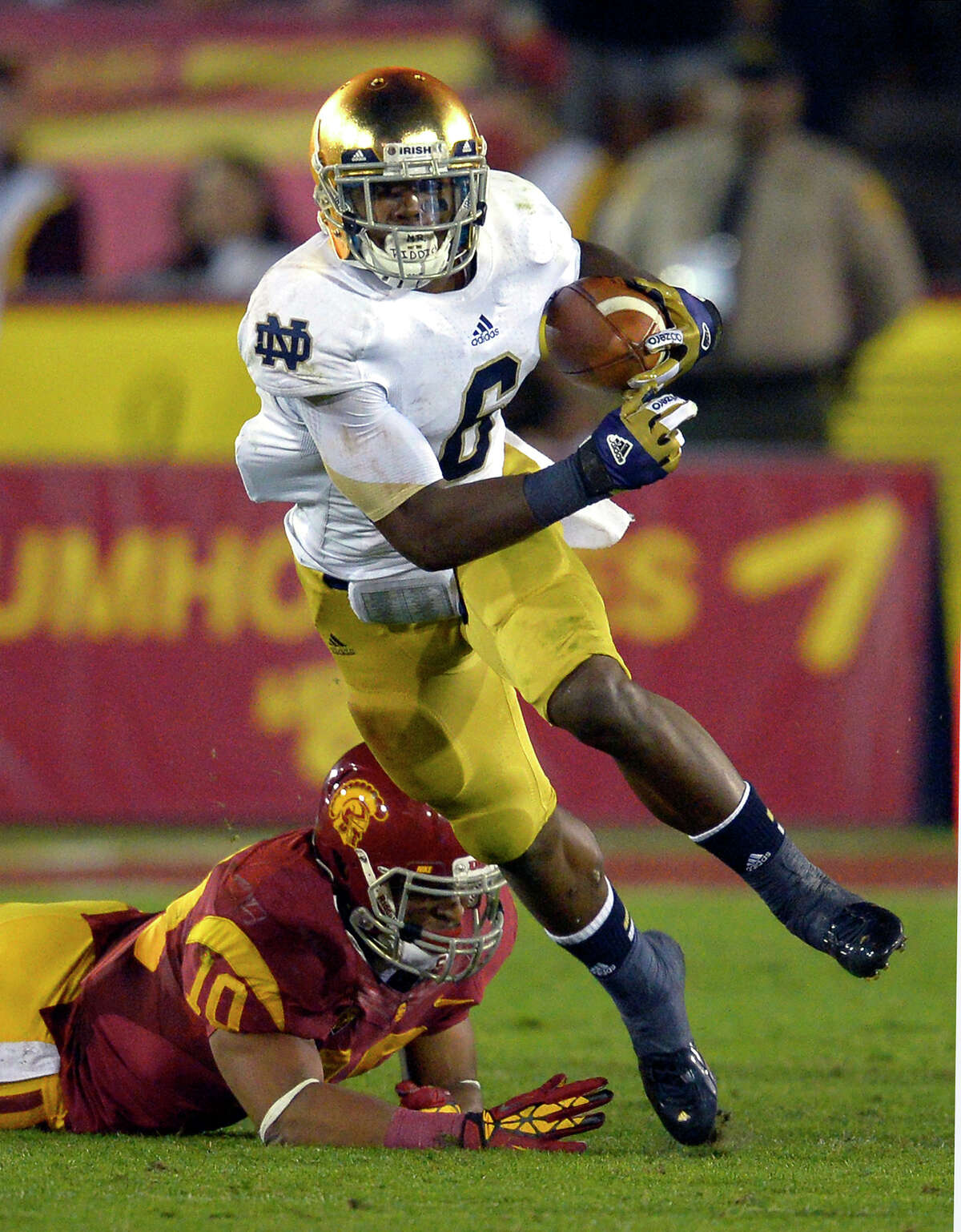 Notre Dame running back Theo Riddick, left, runs the ball as Southern California linebacker Hayes Pullard during the first half of their NCAA college football game, Saturday, Nov. 24, 2012, in Los Angeles. (AP Photo/Mark J. Terrill)