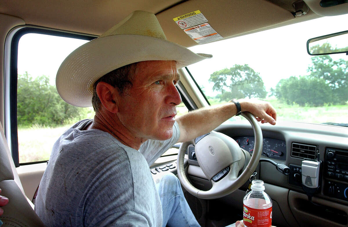 President Bush drives his pickup truck at his ranch in Crawford, Texas, Friday, Aug. 9, 2002, where he is vacationing for nearly a month. At Crawford, the President said, "I'm able to clear my mind and it helps me put it all in perspective". (AP Photo/The White House, Eric Draper)
