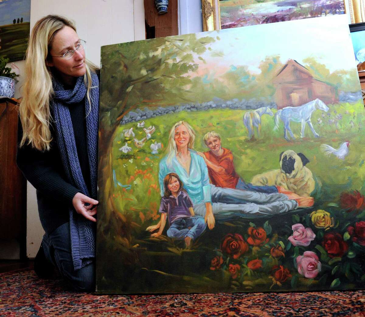 Scarlett Lewis, of Sandy Hook holds a painting that she did depicting herself with sons Jesse and JT on the family farm in Newtown, Thursday, Jan. 3, 2013.