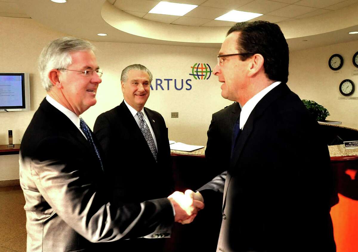 Kevin Kelleher, president and CEO of Cartus, left, and Joe Walkovich, a Greater Danbury Chamber of Commerce member, greet Connecticut Gov. Dannel P. Malloy, right, who was the keynote speaker at a chamber breakfast held at Cartus Tuesday, Jan. 8, 2012.
