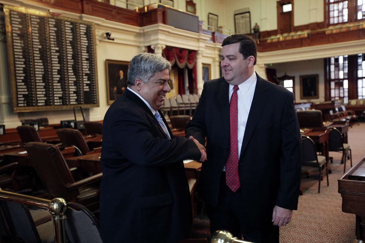 District 62 St. Rep. Larry Phillips, right, shakes hands with outgoing St. Rep. Dist. 40 Aaron Pena (tilde over the n), before the start of the 83rd Texas Legislature at the State Capitol in Austin, Tuesday, Jan. 8, 2013.