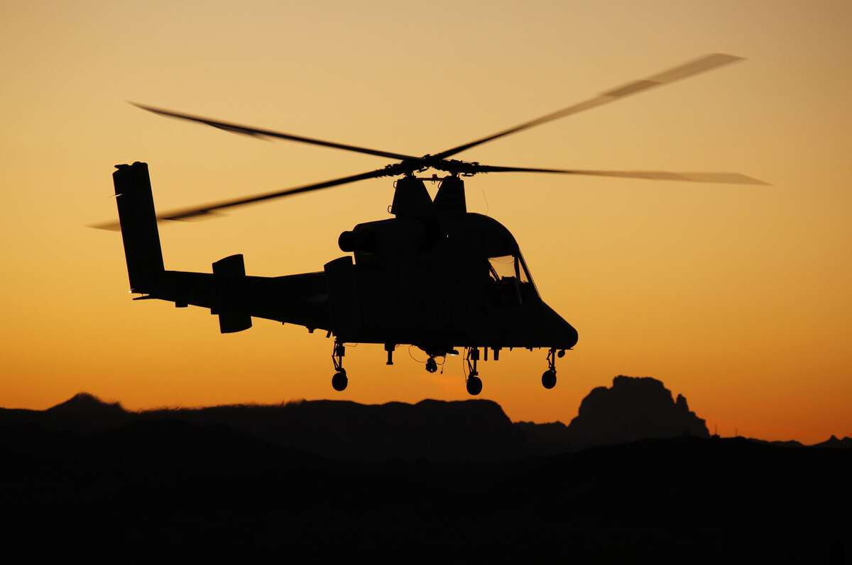 An unmanned K-Max helicopter, which is today delivering supplies in Afghanistan, goes through testing in Arizona. The helicopter was built by Connecticut-based Kaman Aerospace.
