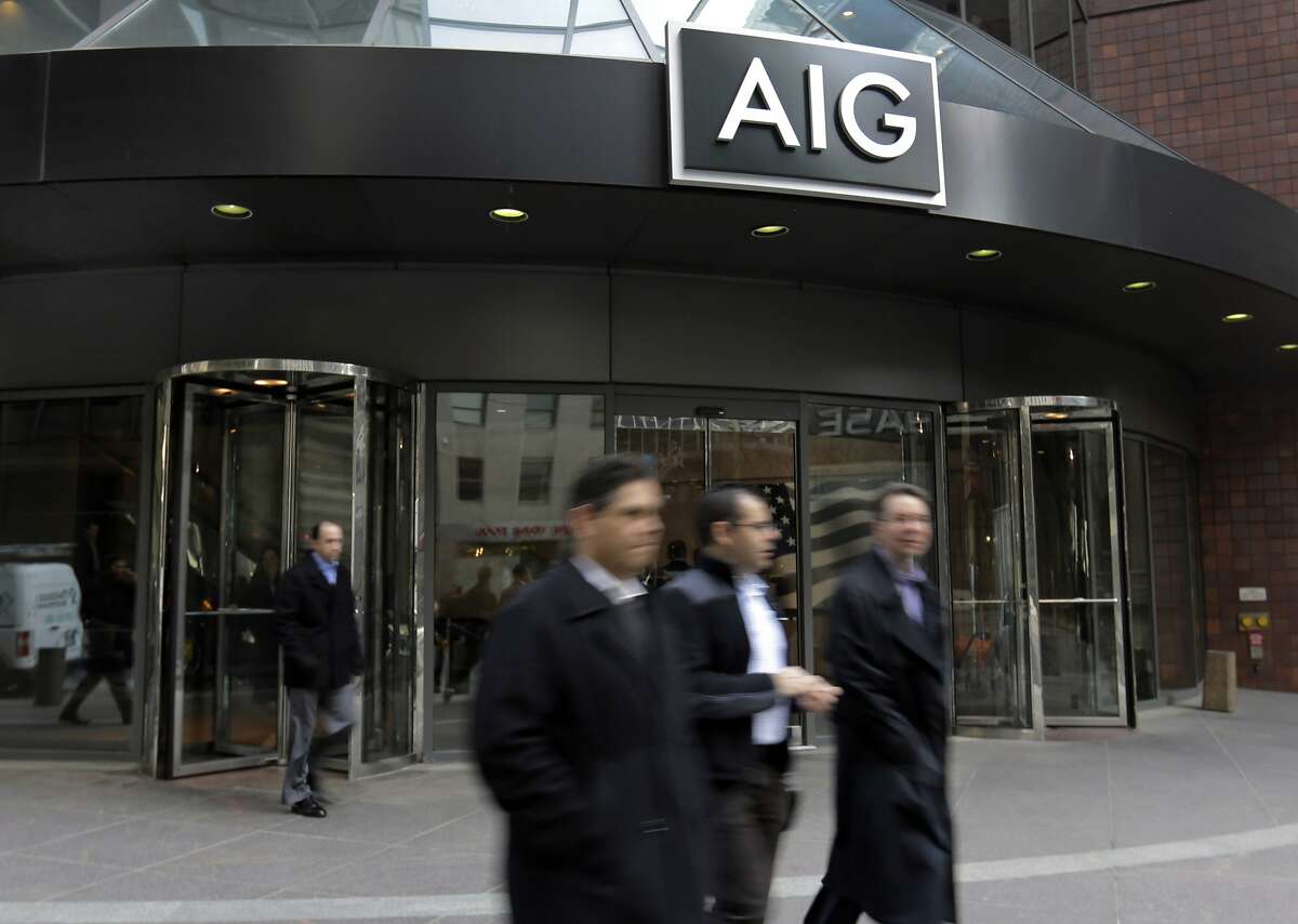 People pass the AIG building, in New York, Tuesday, Jan. 8, 2013. (AP Photo/Richard Drew) STANDALONE PHOTO