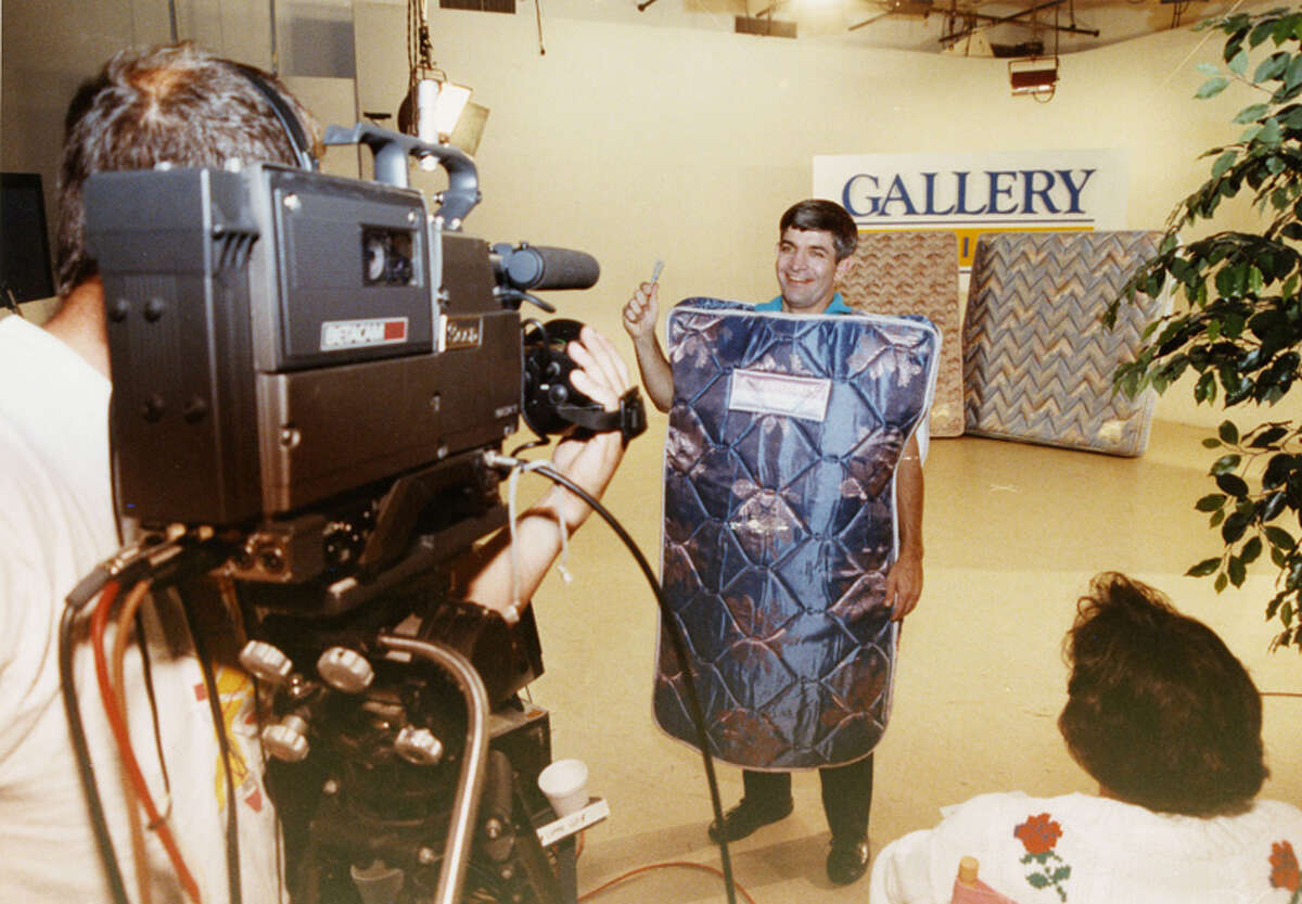 He's called Mattress Mack because he used to wear a mattress in his Gallery Furniture commercials. Here he is in 1990, filming one.