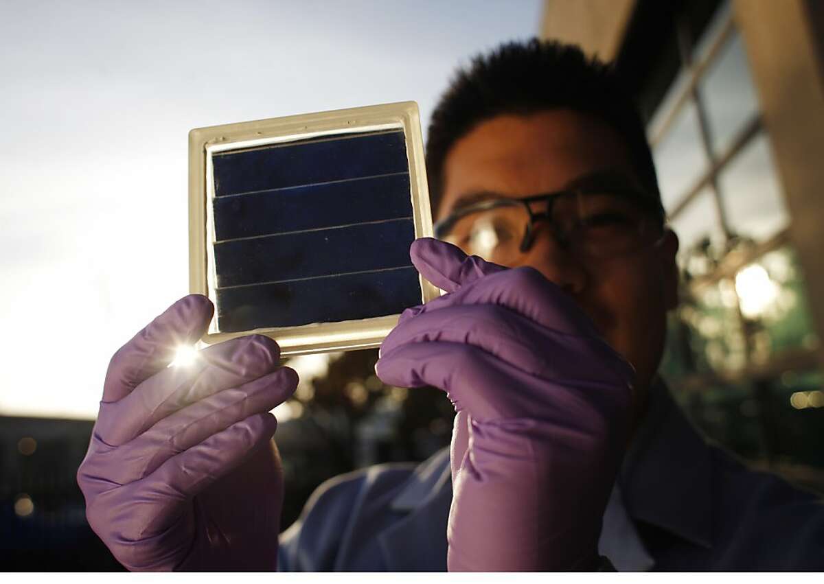 Kenny Lee, a mechanical engineer at the Joint Center for Artificial Photosynthesis holds a prototype of an artificial photosynthesis panel on Wednesday January 9, 2012 in Berkeley, Calif. JCAP has entered a race to create earth friendly fuels that some day may actual combat the effects of global warming.