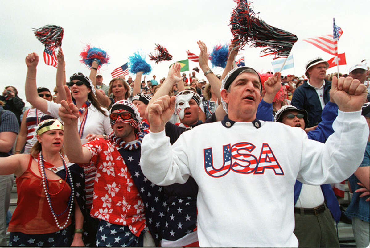 Jim "Mattress Mack" McIngvale, right, joins fans known as The Netheads for the opening ceremony at Davis Cup quarterfinals doubles match on Saturday, April 6, 2002 at Westside. Related story.
