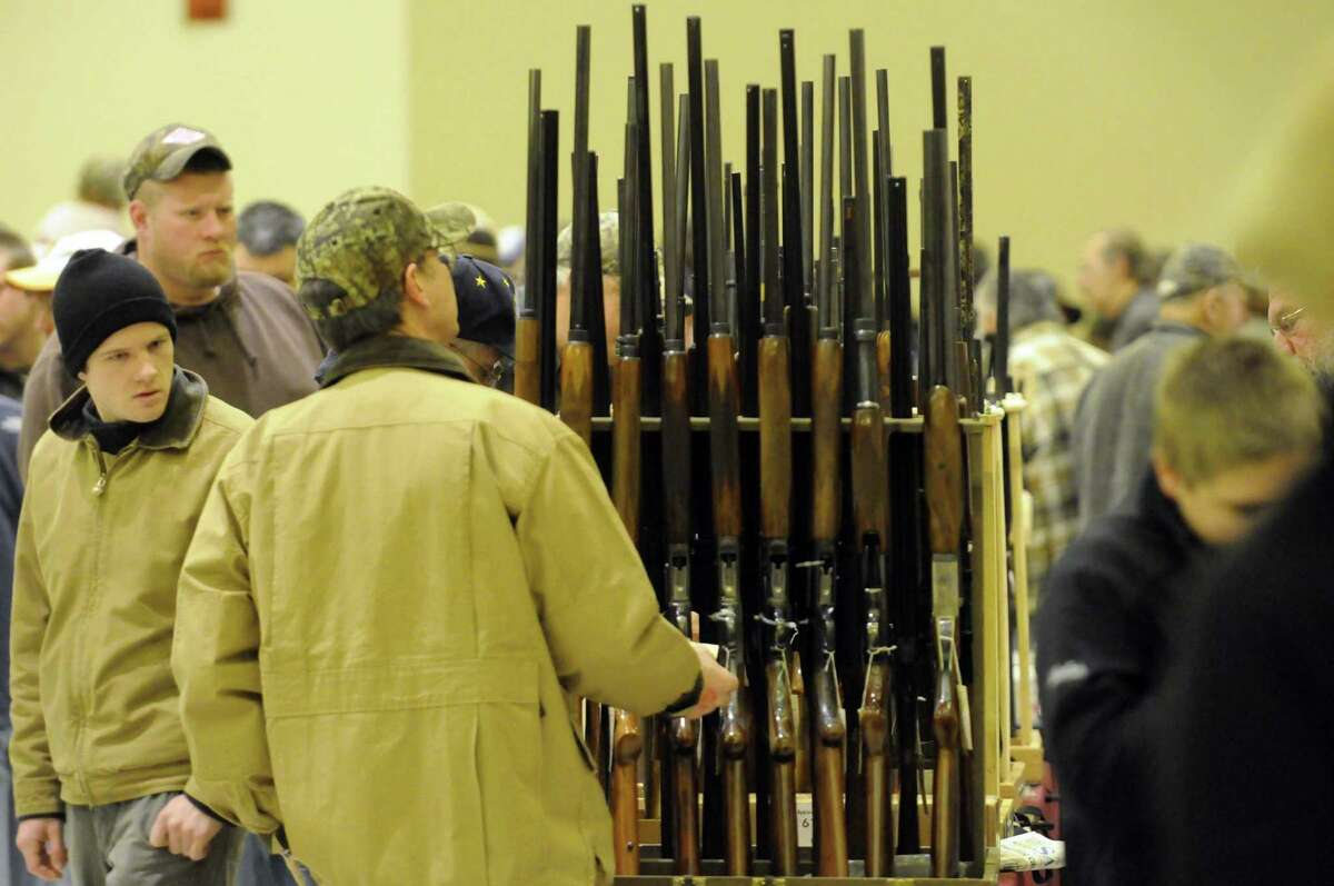 Firearm enthusiast look over the offerings at the Saratoga Springs gun show on Saturday Jan. 12,2013 in Saratoga Springs, N.Y. (Michael P. Farrell/Times Union)