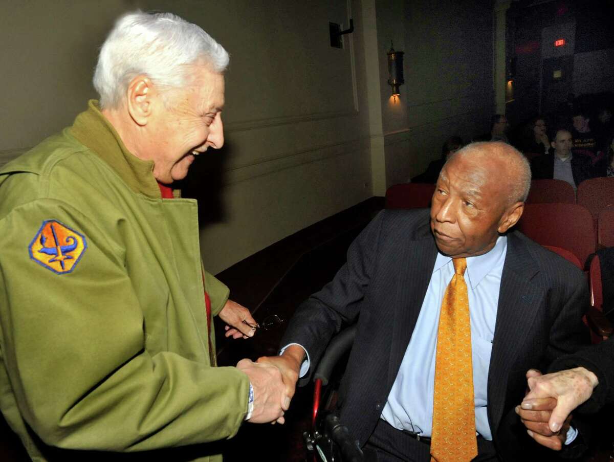 In this file photo Pasquale Pepe, of Shelton, left, greets Jeff Wiggins at the showing of "The Fields of Margraten: Bitter Harvest." Pepe fought in one of the battles near Margraten that led to Jefferson's Army company digging the largest grave for U.S. forces in World War II. The film was shown as the closing selection of the Connecticut Film Festival at The Palace Theatre in Danbury, Sunday, April 10, 2011.