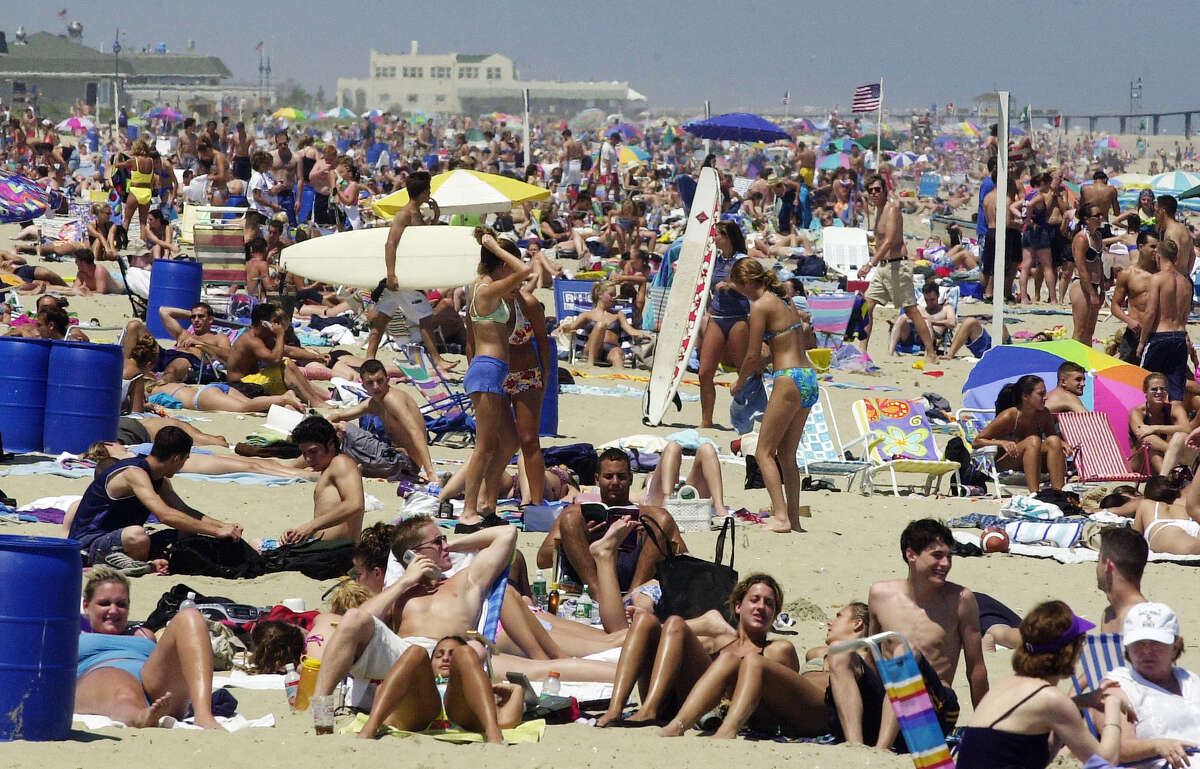 Visitors and residents spend the day on the beach in Belmar, N.J., on this first day of summer. (Associated Press)