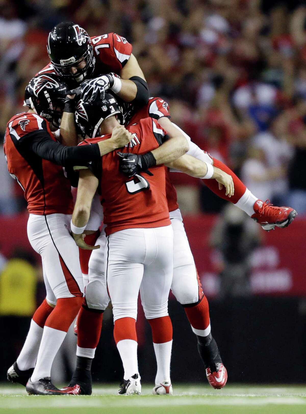 Atlanta Falcons kicker Matt Bryant (3) is congratulated by teammates after making the game-winning field goal during the second half of an NFC divisional playoff NFL football game against the Seattle Seahawks Sunday, Jan. 13, 2013, in Atlanta. The Falcons won 30-28. (AP Photo/David Goldman)