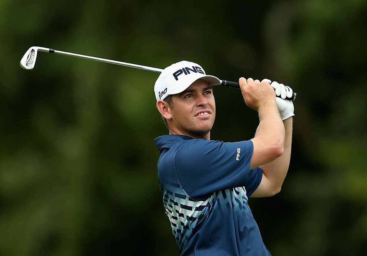 DURBAN, SOUTH AFRICA - JANUARY 13: Louis Oosthuizen of South Africa plays his second shot into the 11th green during the final round of the Volvo Golf Champions at Durban Country Club on January 13, 2013 in Durban, South Africa. (Photo by Warren Little/Getty Images)