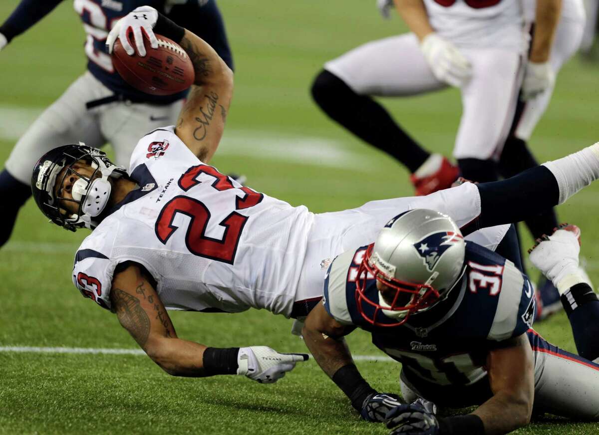 Houston Texans running back Arian Foster reaches forward for a first down after being tackled by New England Patriots cornerback Aqib Talib (31)during the second half of an AFC divisional playoff NFL football game in Foxborough, Mass., Sunday, Jan. 13, 2013. (AP Photo/Charles Krupa)