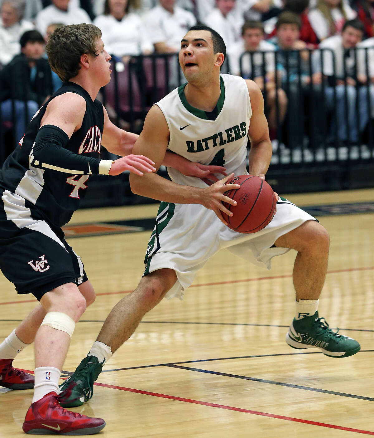 Michael Williams takes a step back looking at the basket as Reagan plays Churchill at Littleton Gym on January 15, 2013.